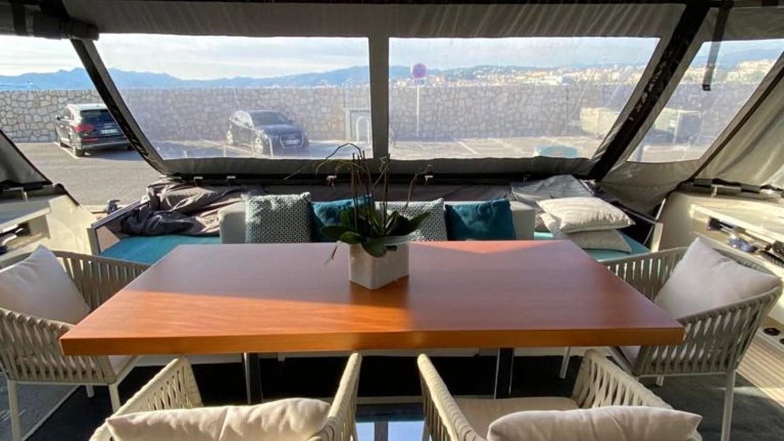 a table with chairs and a plant on it aboard NUMERO 5 Yacht for Sale