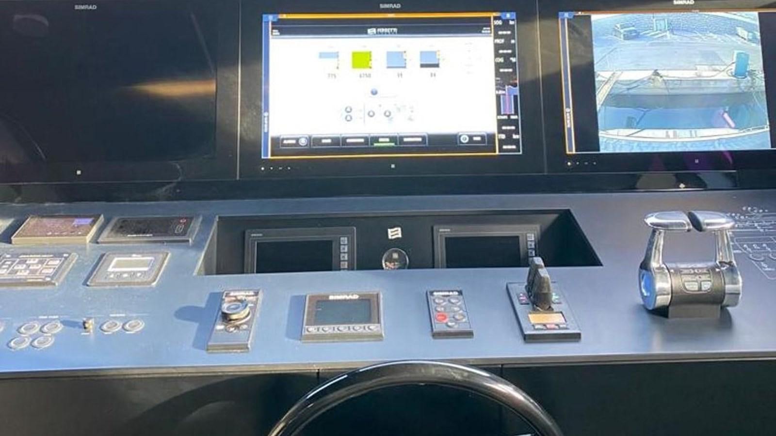 a video game console and a game controller on a table aboard NUMERO 5 Yacht for Sale