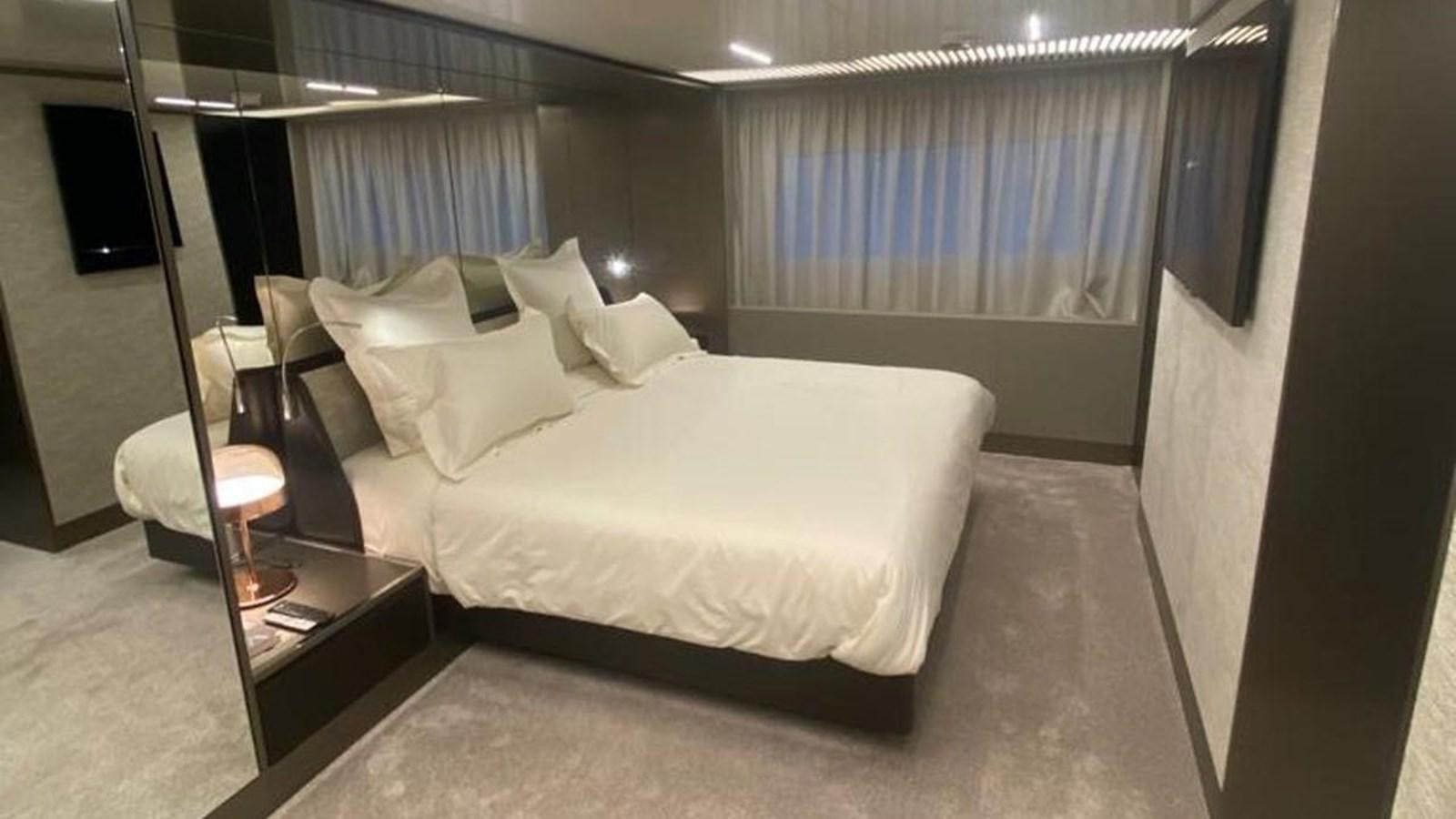 a room with a bed and a television aboard NUMERO 5 Yacht for Sale