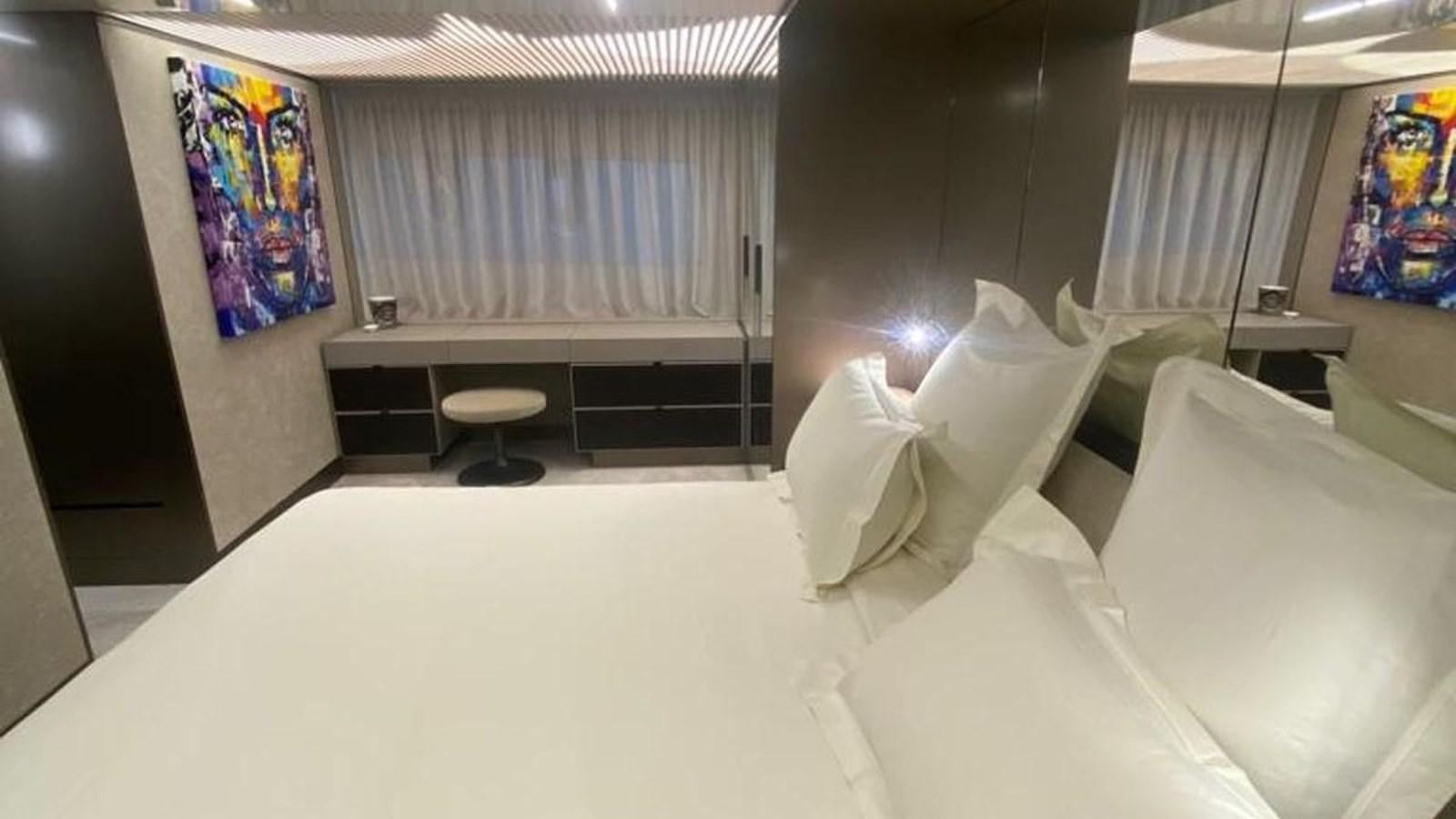 a room with a bed and a chair aboard NUMERO 5 Yacht for Sale