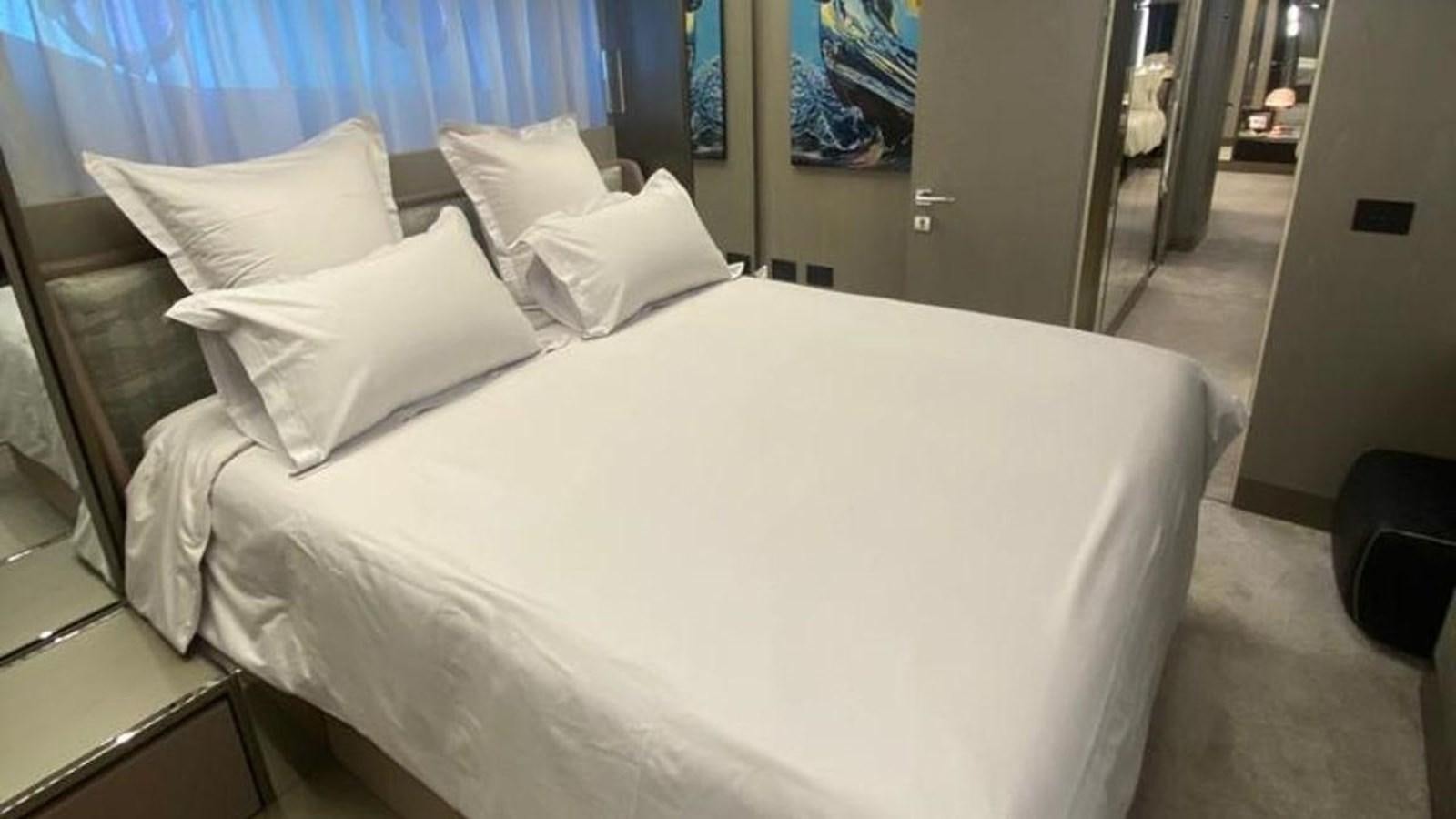 a bed with white sheets aboard NUMERO 5 Yacht for Sale