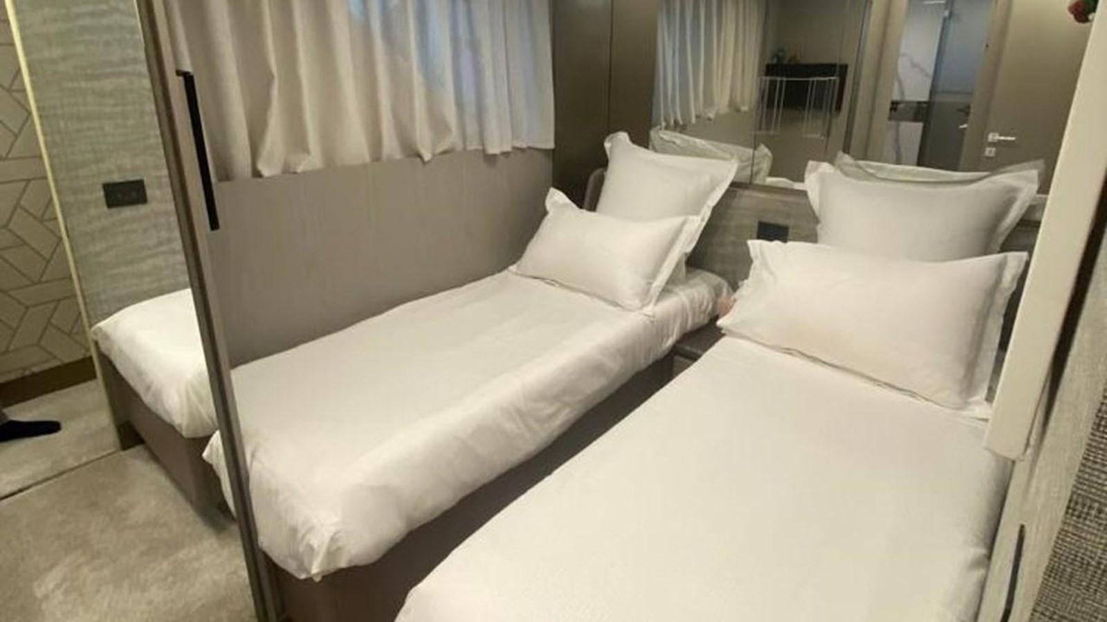 a room with a couple of beds aboard NUMERO 5 Yacht for Sale