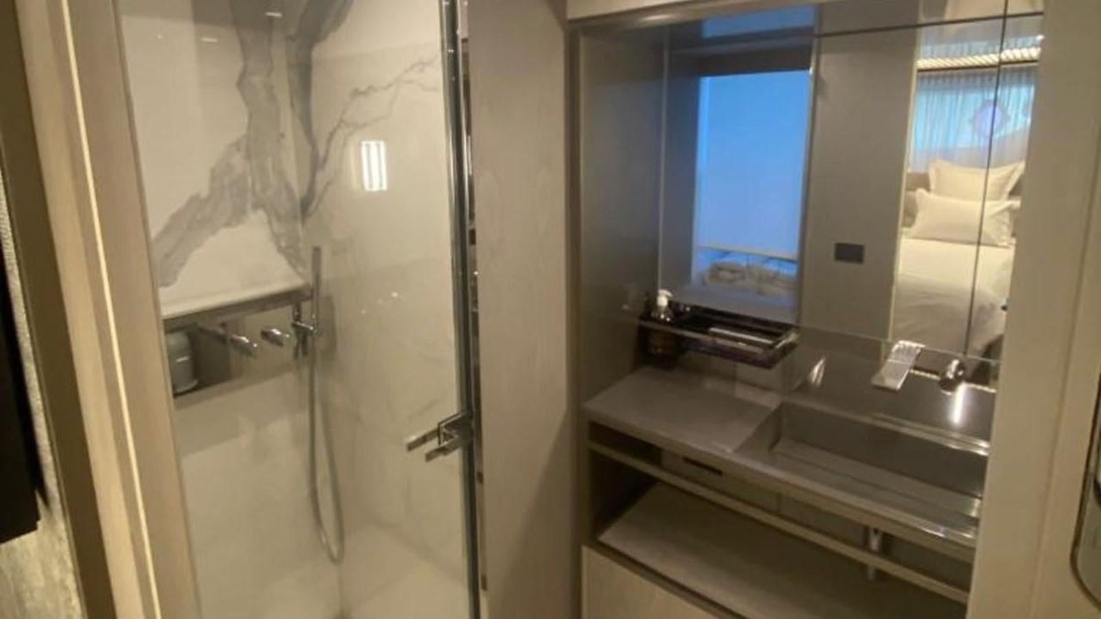 a bathroom with a large mirror aboard NUMERO 5 Yacht for Sale
