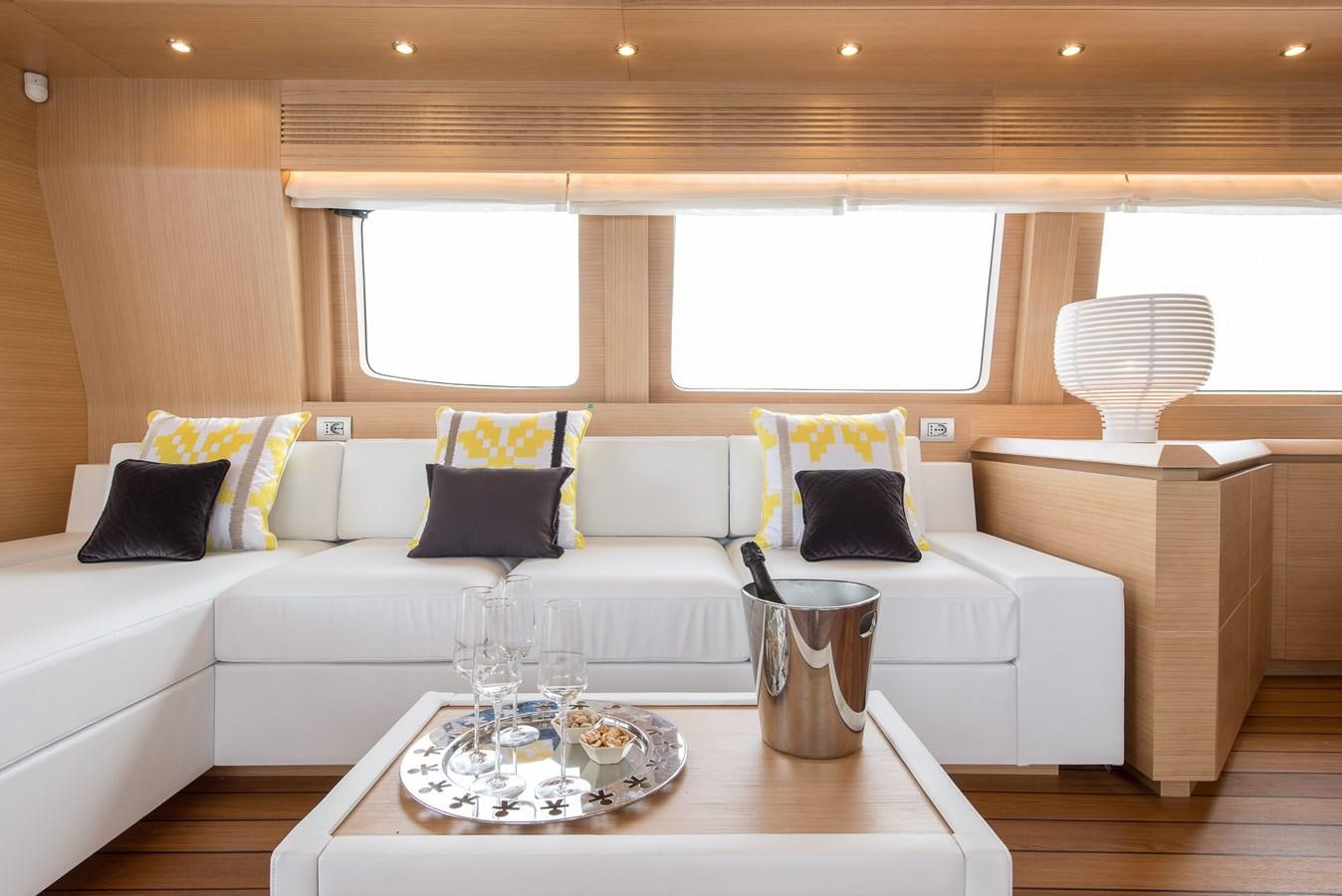 a living room with a white couch and a table aboard MIREDO Yacht for Sale