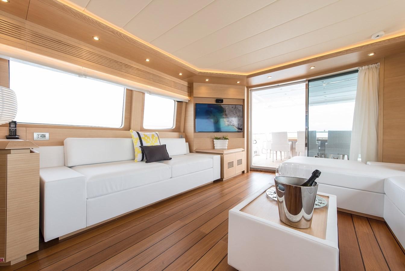a living room with a couch and a coffee table aboard MIREDO Yacht for Sale