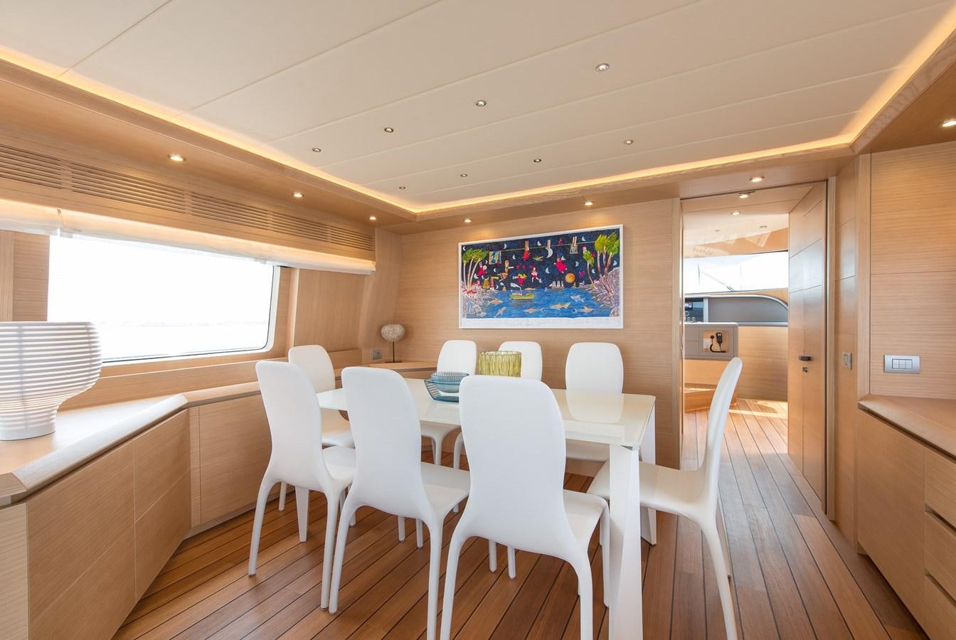 a room with a table and chairs aboard MIREDO Yacht for Sale