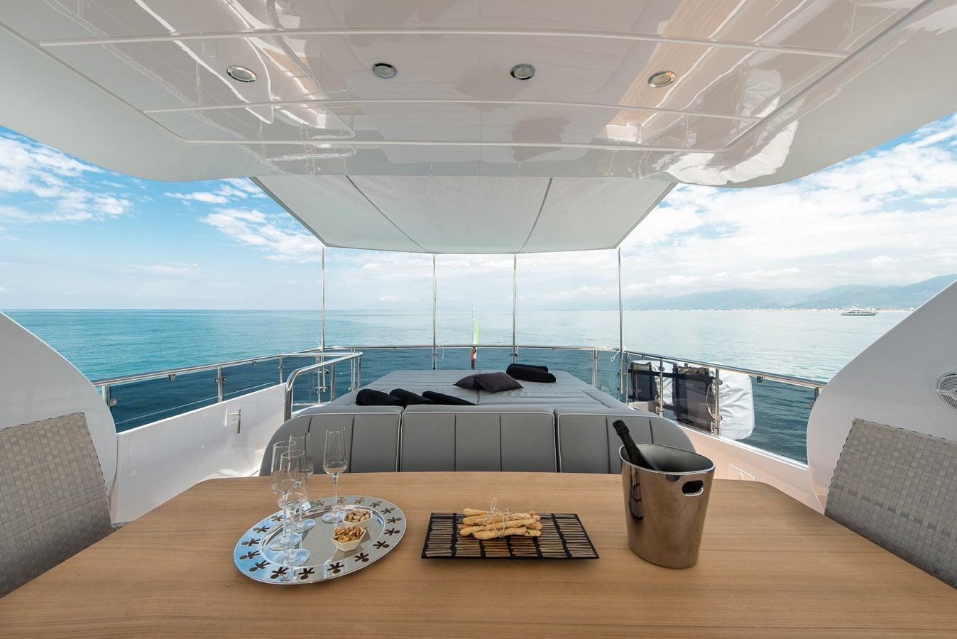 a room with a table and chairs aboard MIREDO Yacht for Sale