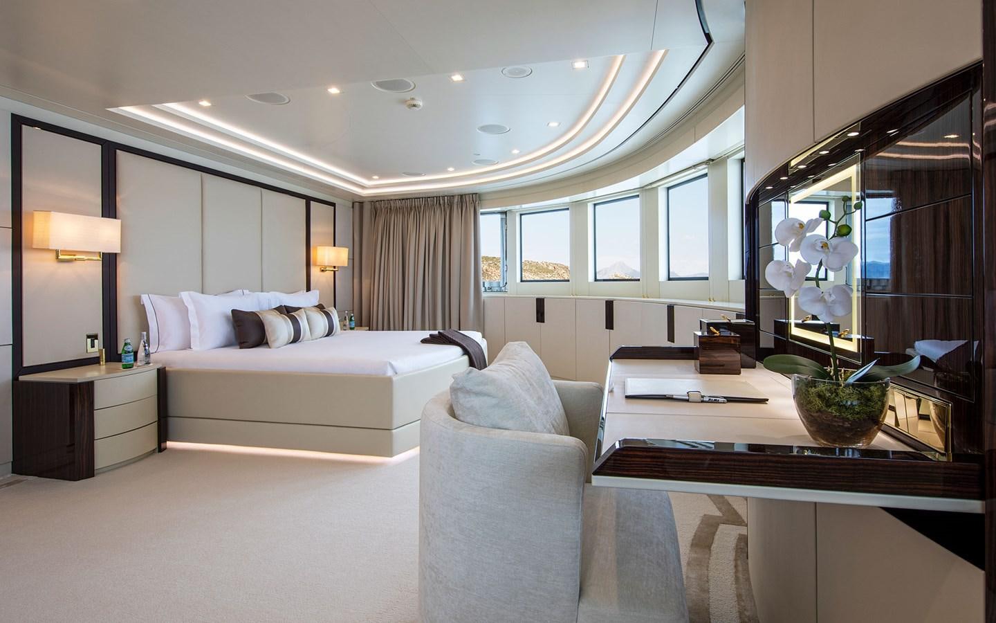 a large white bedroom with a large mirror aboard ROMA Yacht for Sale