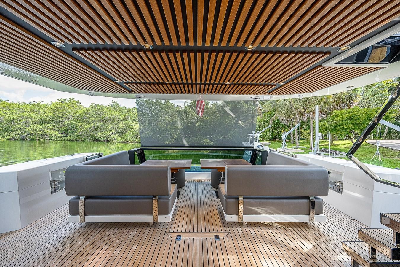 a covered patio with a picnic table and benches aboard SO SO NICE Yacht for Sale