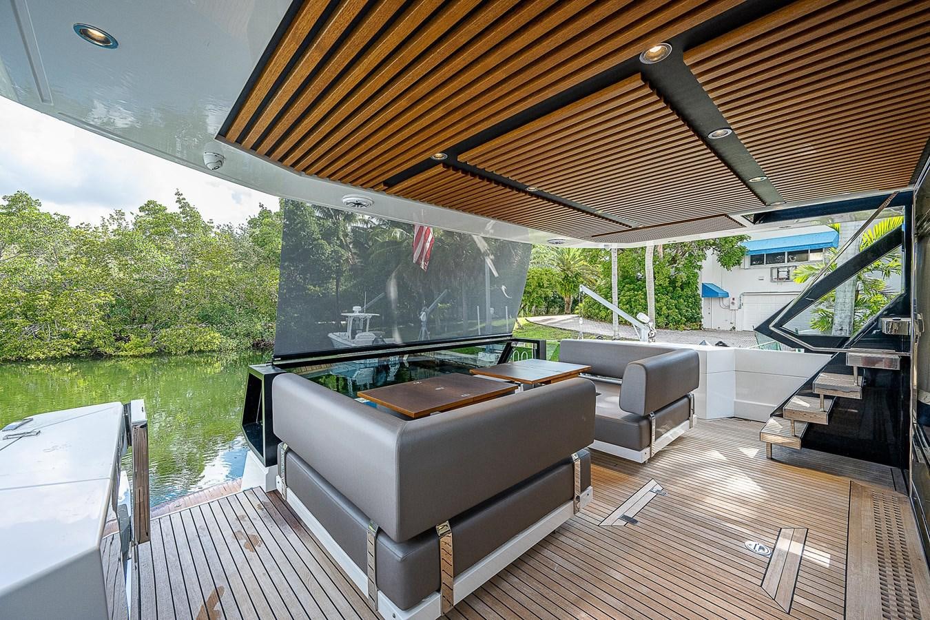 a large living room with a large screen and a deck aboard SO SO NICE Yacht for Sale