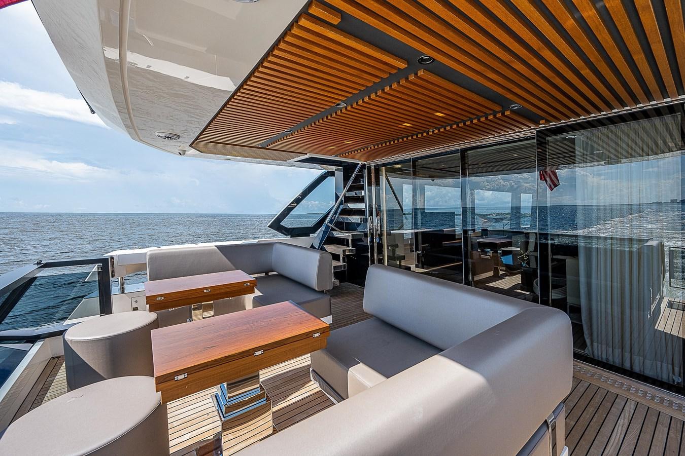 a boat with a deck and a view of the water aboard SO SO NICE Yacht for Sale