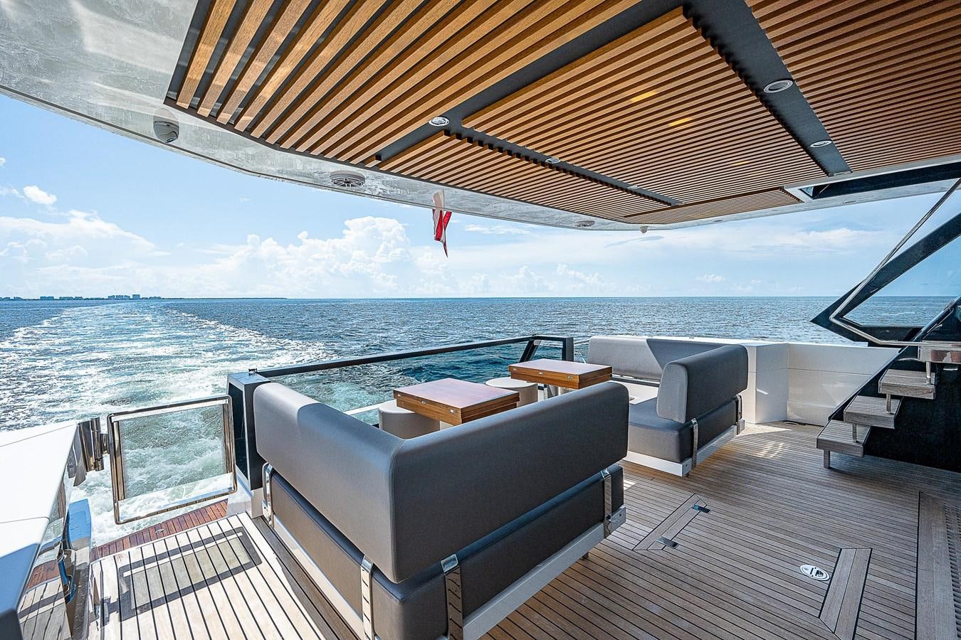 a deck with a view of the ocean and the ocean aboard SO SO NICE Yacht for Sale