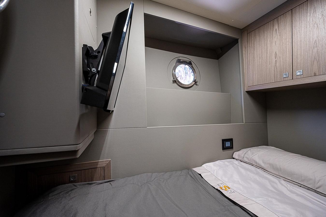 a room with a bed and a desk aboard SO SO NICE Yacht for Sale