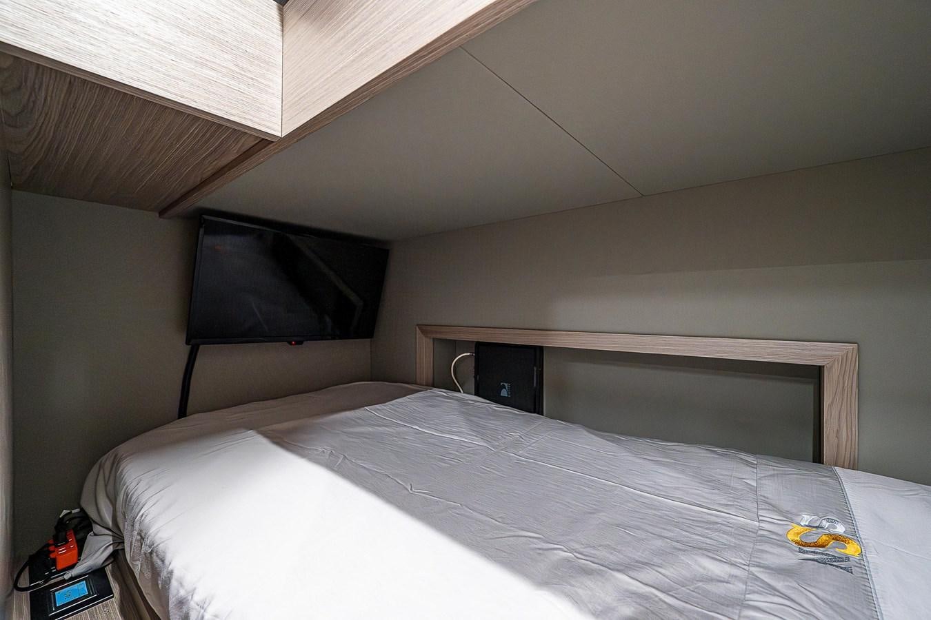 a bed with a white sheet aboard SO SO NICE Yacht for Sale