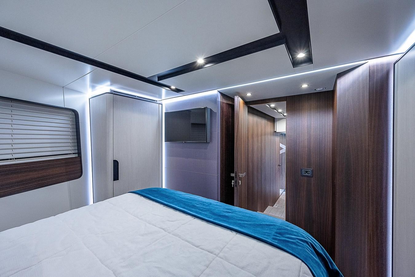 a room with a bed and a closet aboard SO SO NICE Yacht for Sale