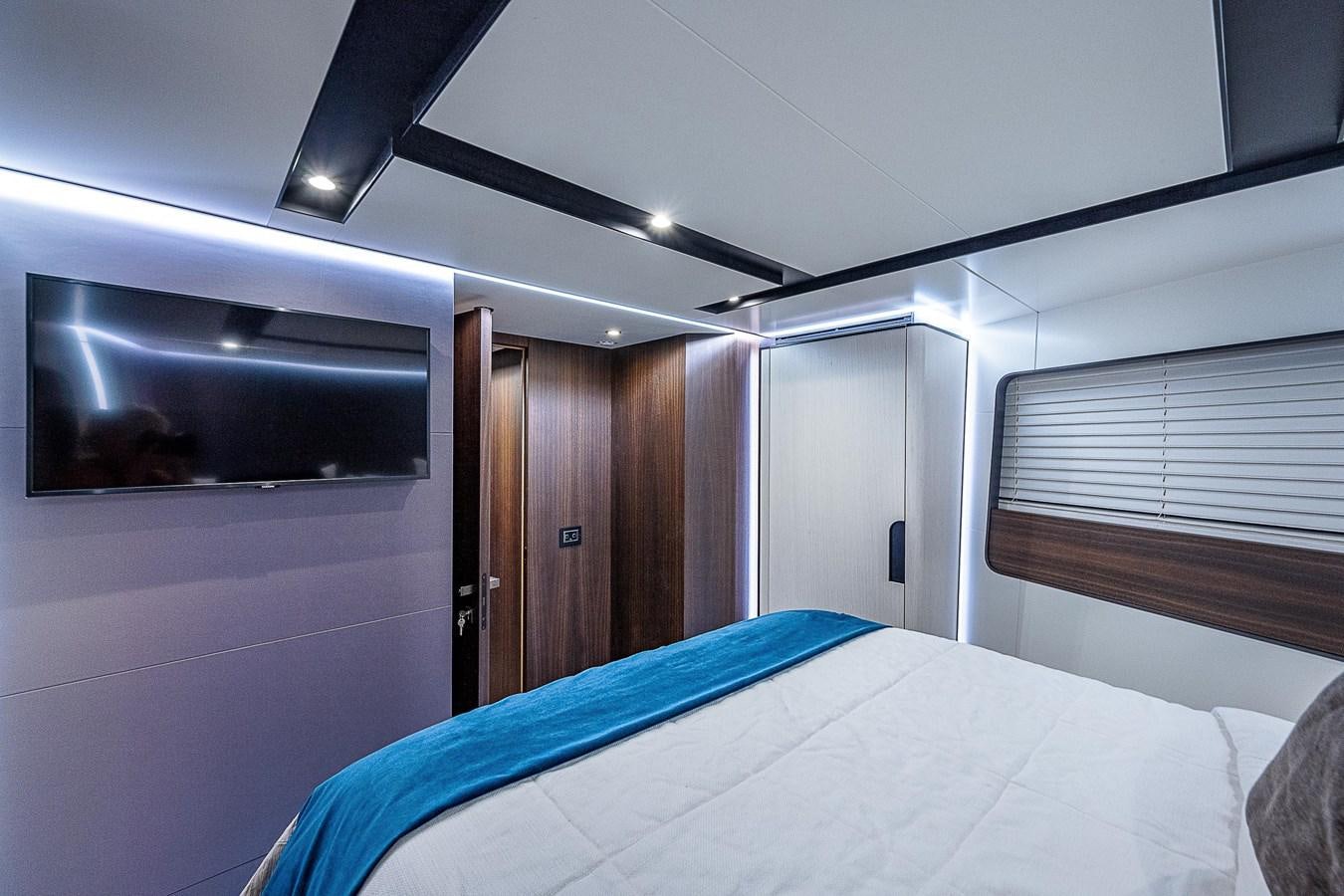 a bedroom with a bed and a television aboard SO SO NICE Yacht for Sale