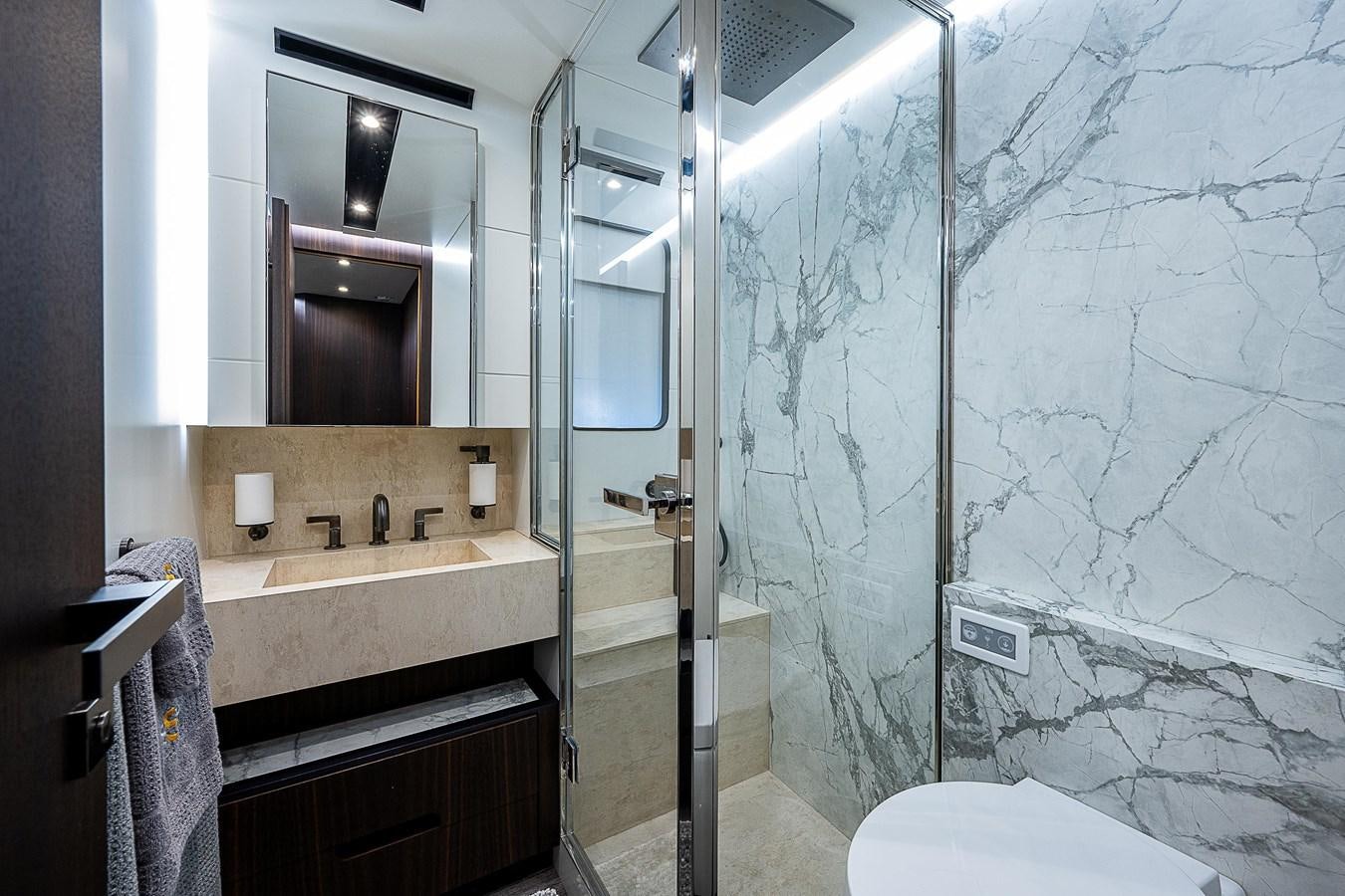 a bathroom with a glass shower aboard SO SO NICE Yacht for Sale
