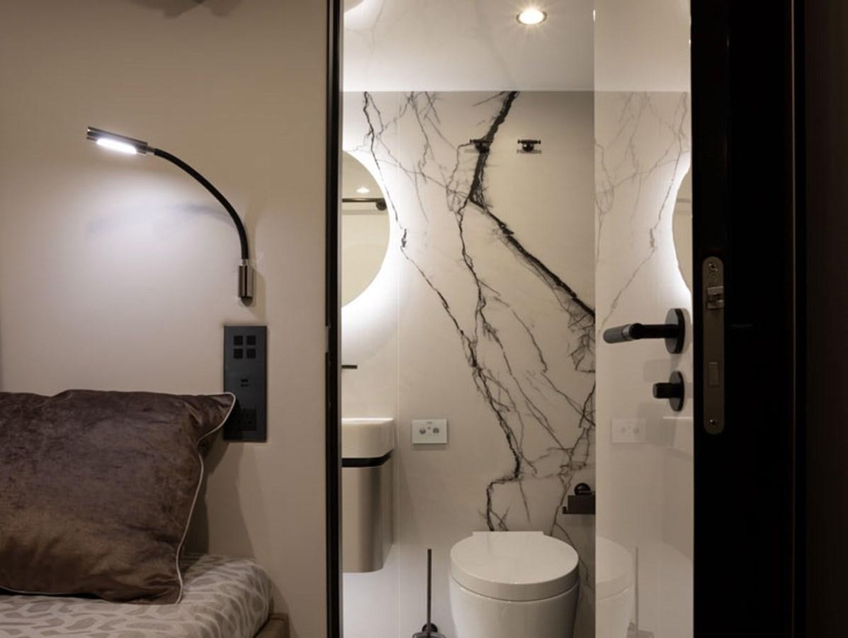 a bathroom with a lamp and a mirror aboard SUNREEF 80 POWER Yacht for Sale