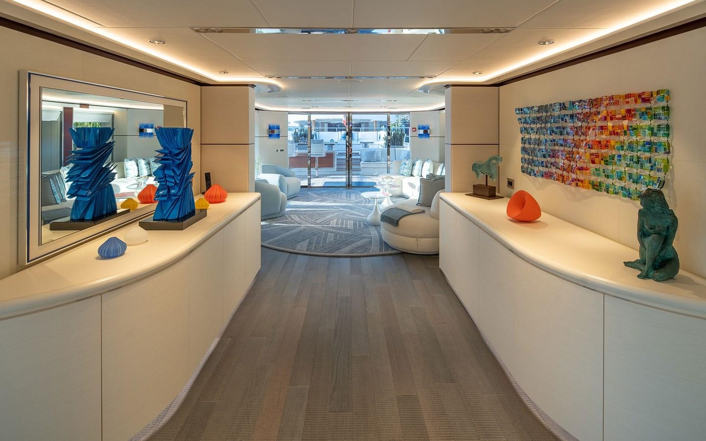 a room with a large mirror and a wood floor aboard BOOK ENDS Yacht for Sale