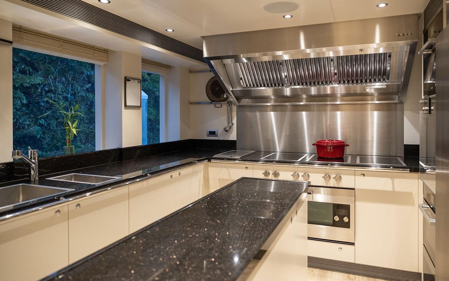 a kitchen with a stainless steel stove aboard BOOK ENDS Yacht for Sale