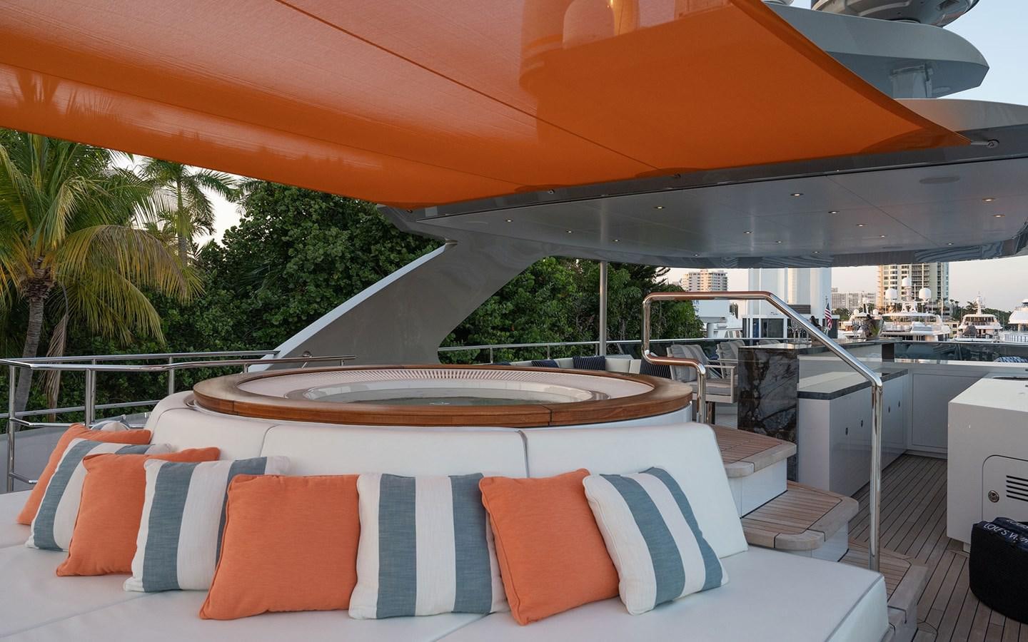 a lounge area with a large umbrella aboard BOOK ENDS Yacht for Sale