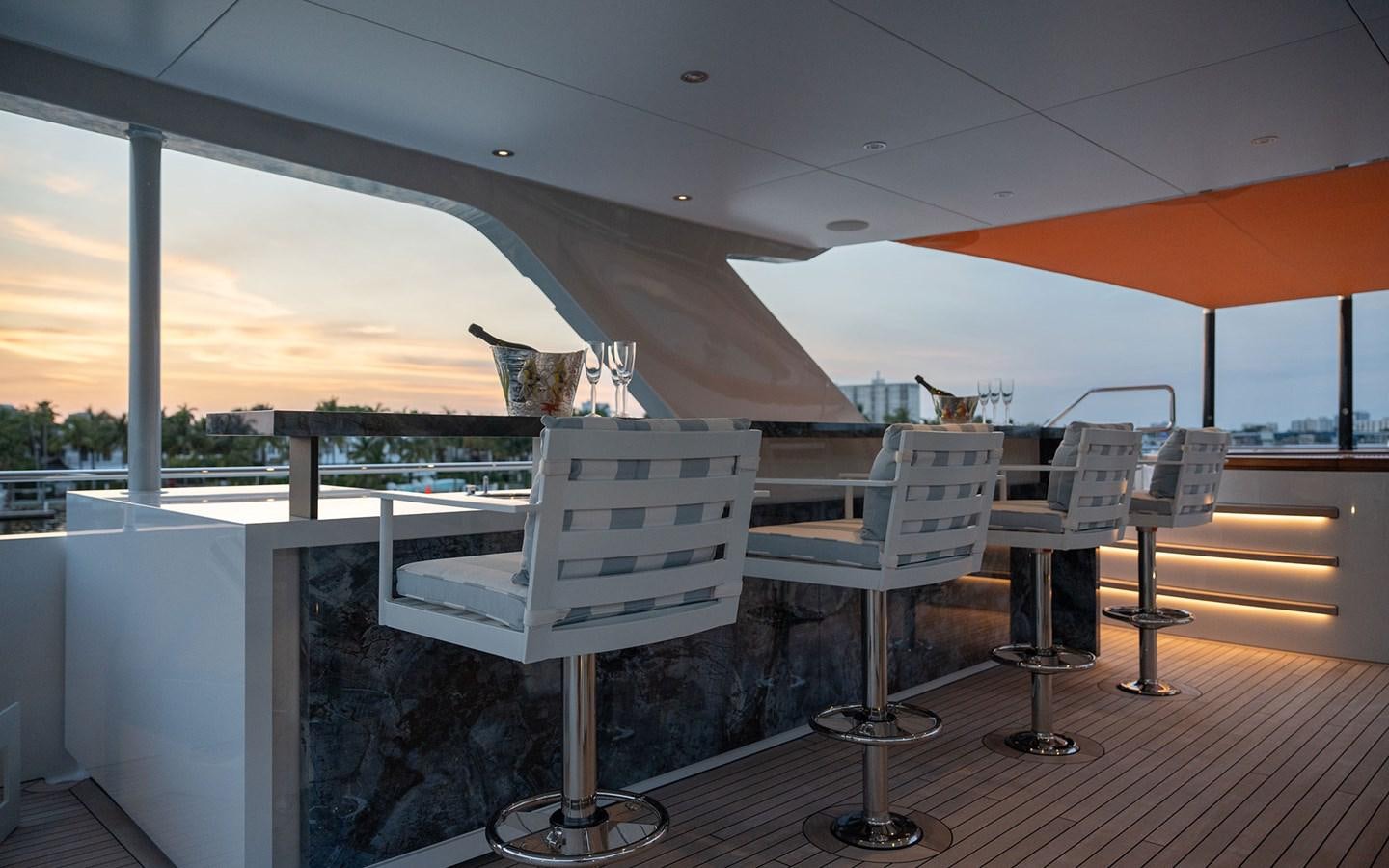 a table and chairs on a patio aboard BOOK ENDS Yacht for Sale