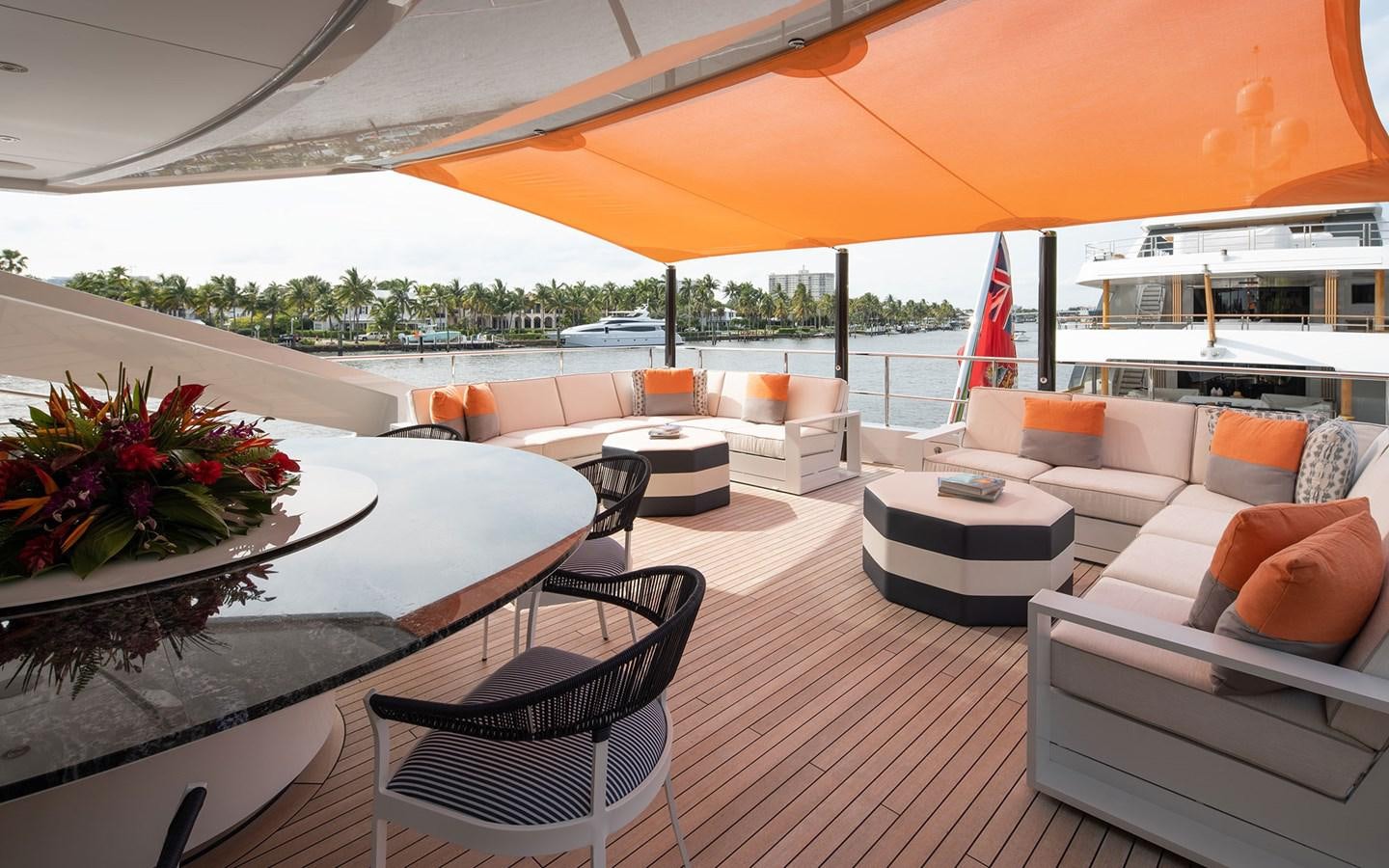 a large open living room with a large umbrella aboard BOOK ENDS Yacht for Sale