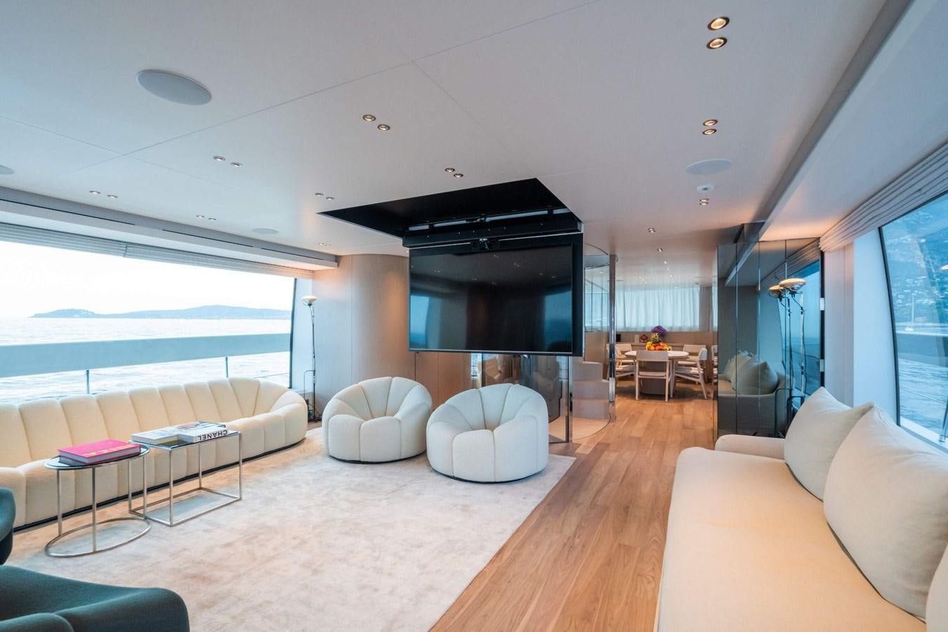 a living room with a large fireplace aboard AMI Yacht for Sale