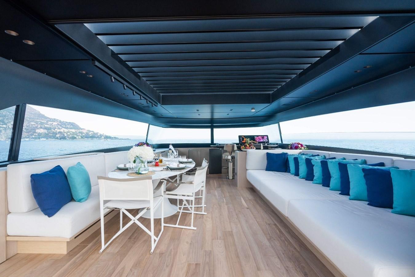 a room with a table and chairs aboard AMI Yacht for Sale