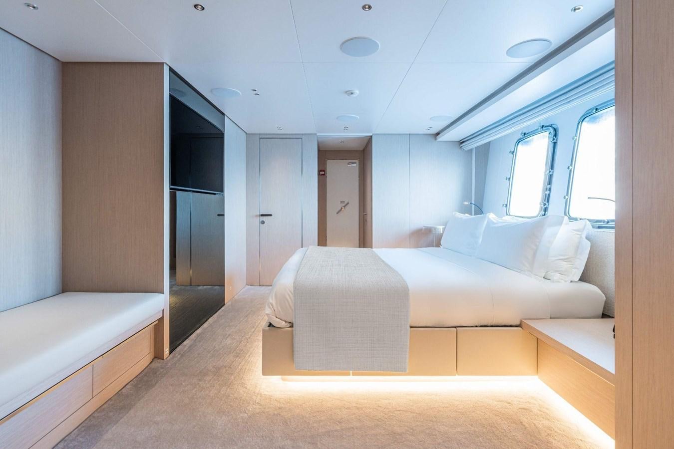 a room with a bed and a window aboard AMI Yacht for Sale