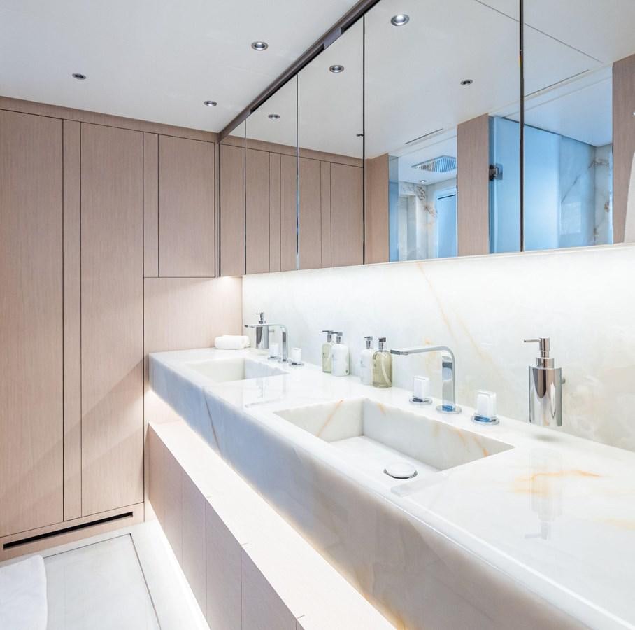 a bathroom with a large mirror aboard AMI Yacht for Sale