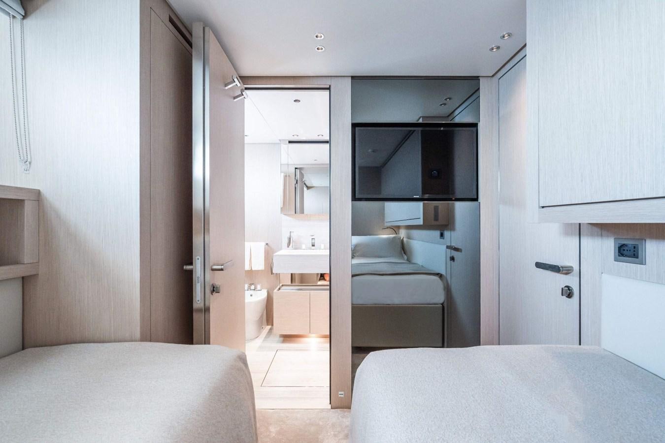a bedroom with a bed and a closet aboard AMI Yacht for Sale