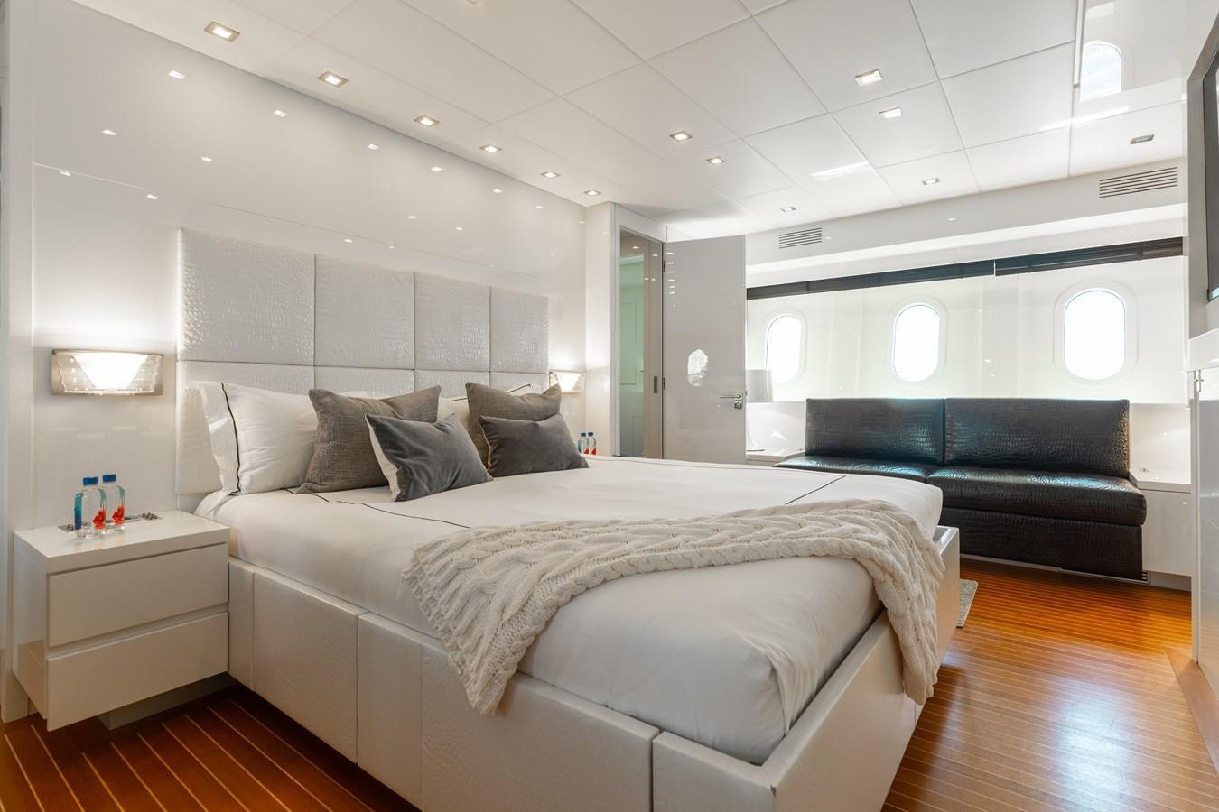 a bedroom with a bed and a couch aboard VENTURE Yacht for Sale