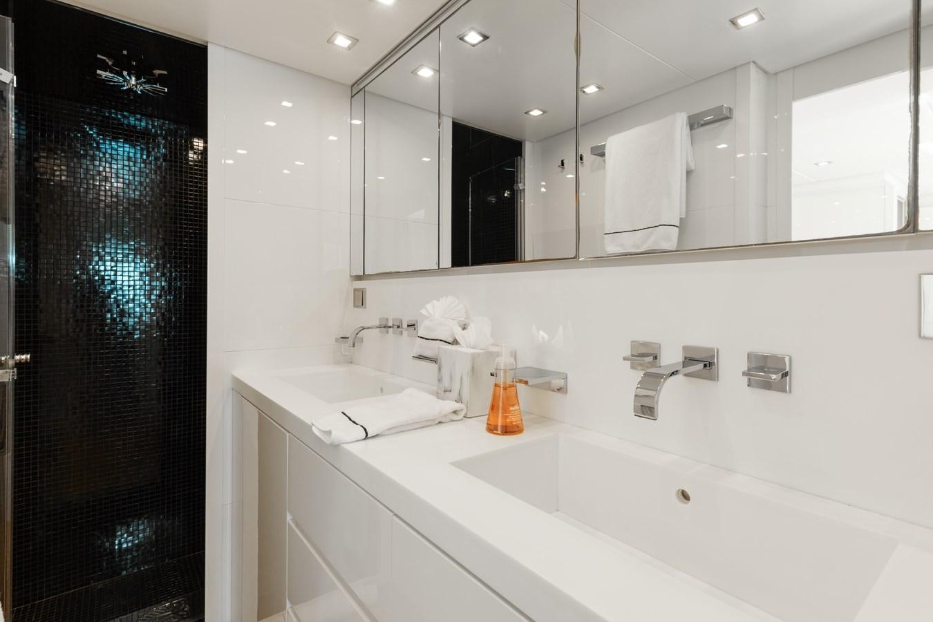 a bathroom with a large mirror aboard VENTURE Yacht for Sale