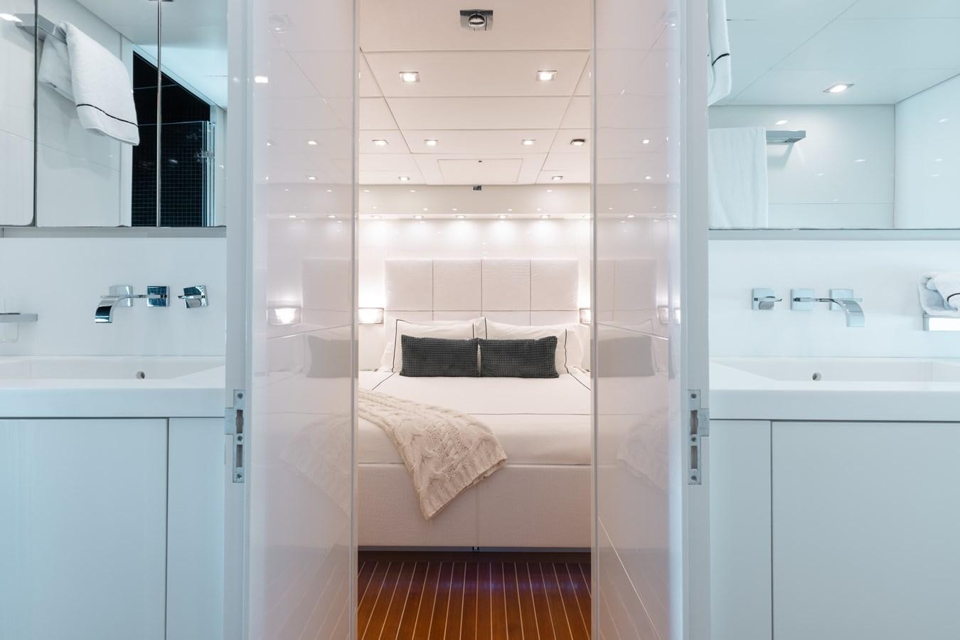 a bathroom with a bed and a sink aboard VENTURE Yacht for Sale