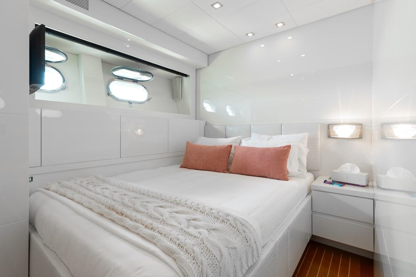 a bed with a white bed spread aboard VENTURE Yacht for Sale
