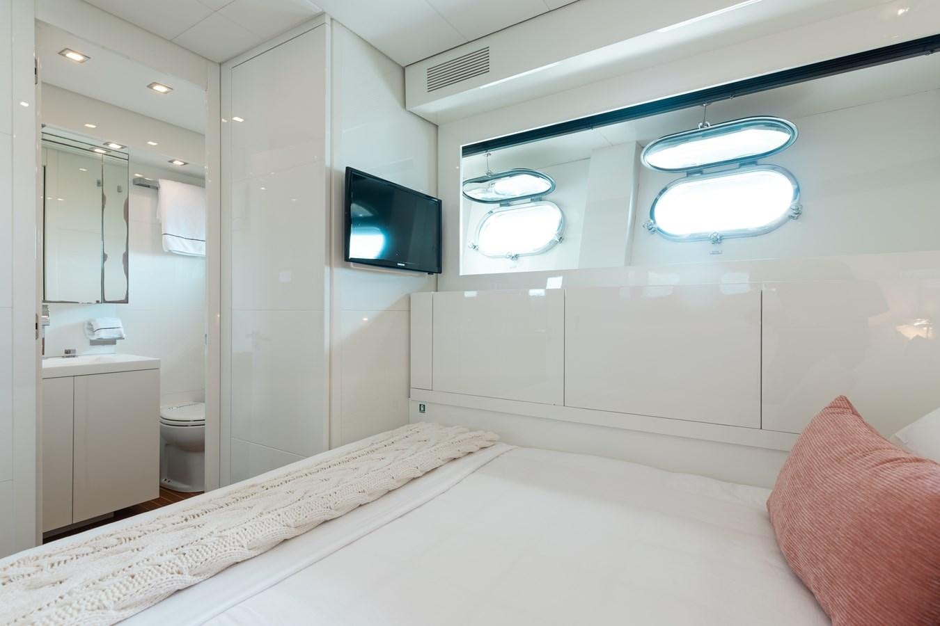 a room with a tv and a bed aboard VENTURE Yacht for Sale