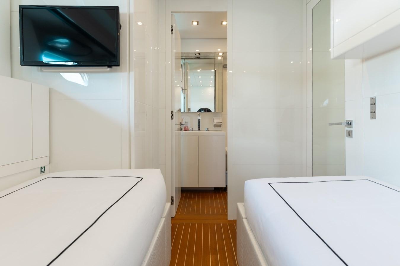 a bathroom with a tv on the wall aboard VENTURE Yacht for Sale