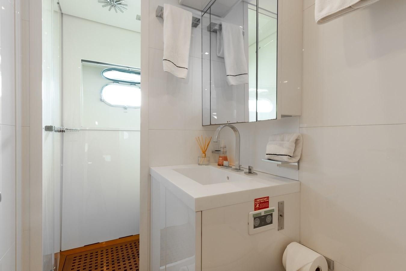 a bathroom with a sink and mirror aboard VENTURE Yacht for Sale