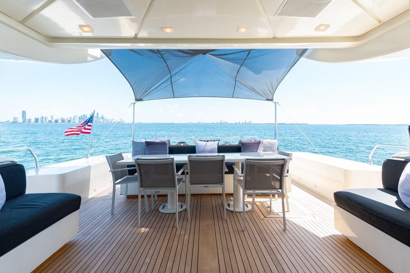 a deck with chairs and a large umbrella on it aboard VENTURE Yacht for Sale