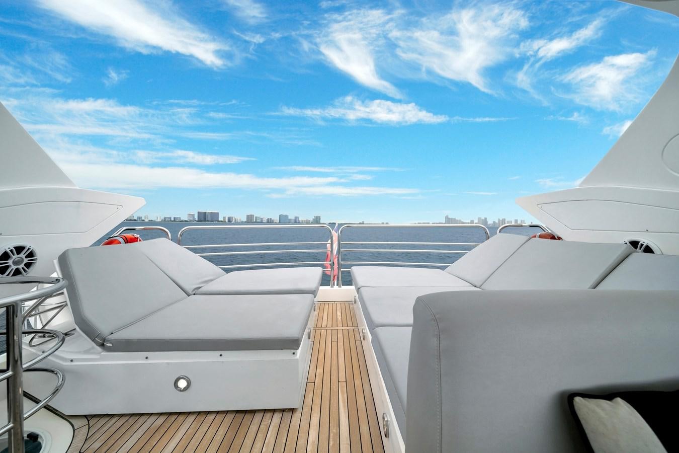 a deck with a view of the water and the land below aboard QUATTRO Yacht for Sale