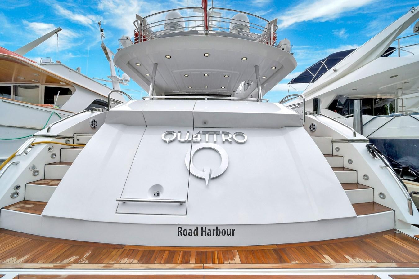 a white boat with a white cover aboard QUATTRO Yacht for Sale