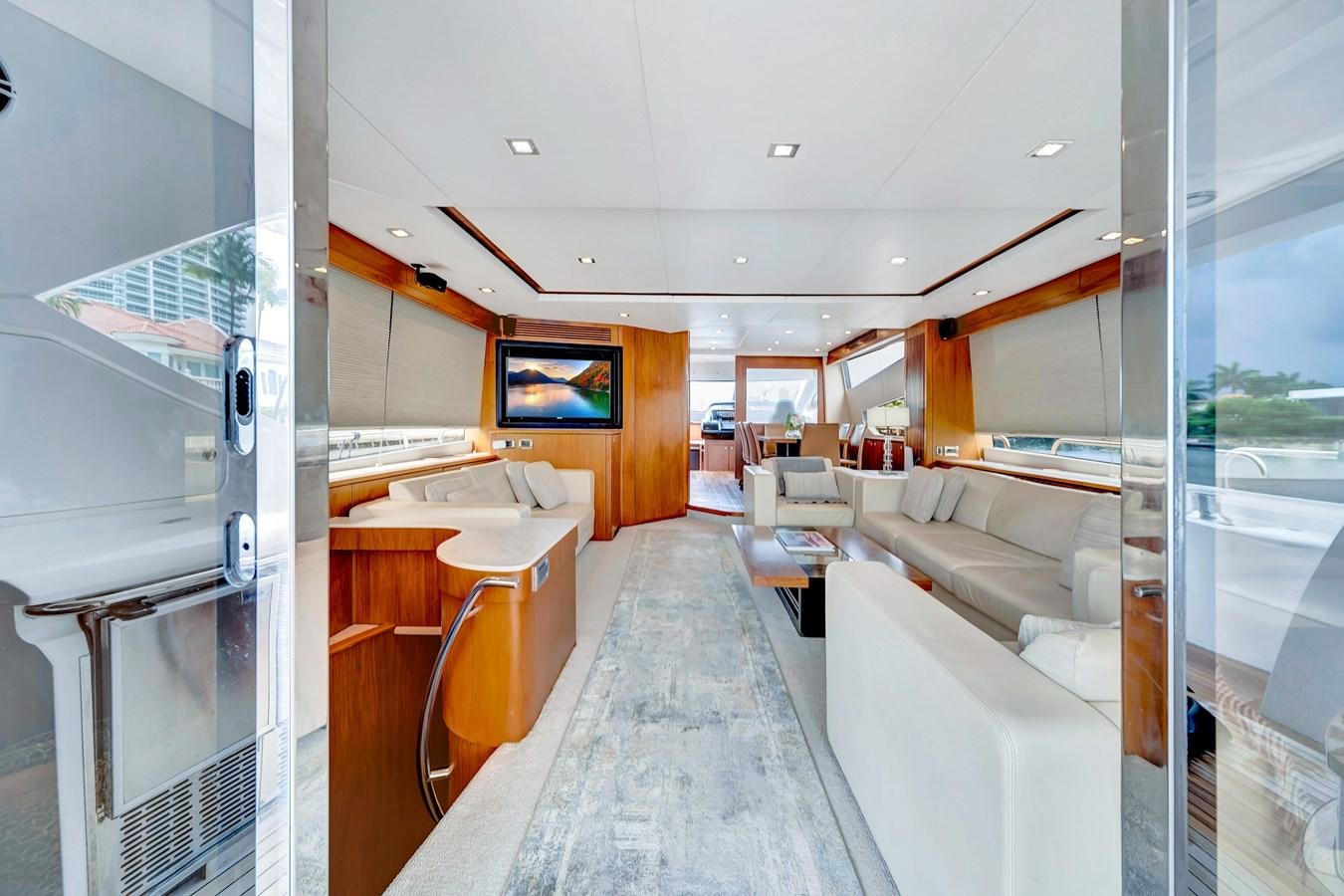 a room with a couch and a tv on the wall aboard QUATTRO Yacht for Sale