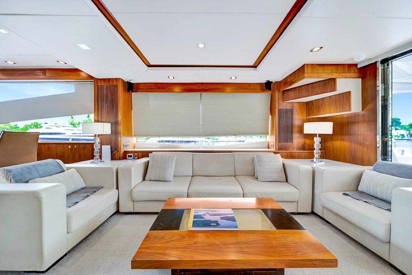 a living room with a couch and a table aboard QUATTRO Yacht for Sale