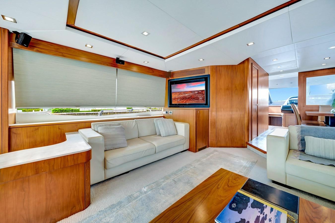a living room with a large wood cabinet aboard QUATTRO Yacht for Sale