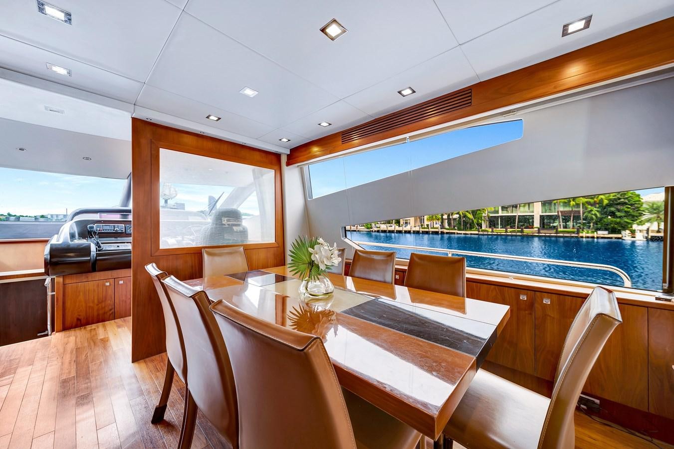 a room with a table and chairs aboard QUATTRO Yacht for Sale