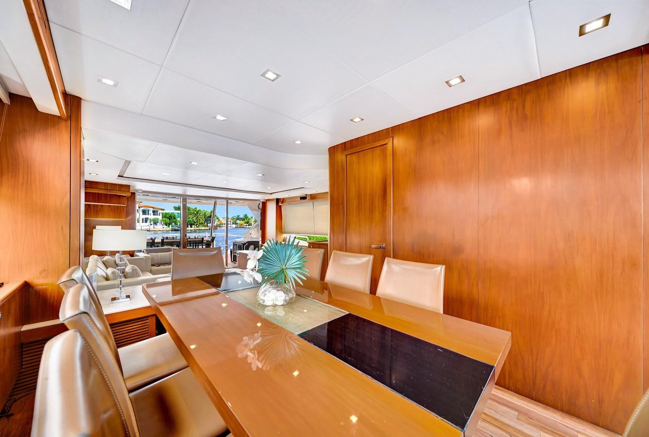 a room with a table and chairs aboard QUATTRO Yacht for Sale