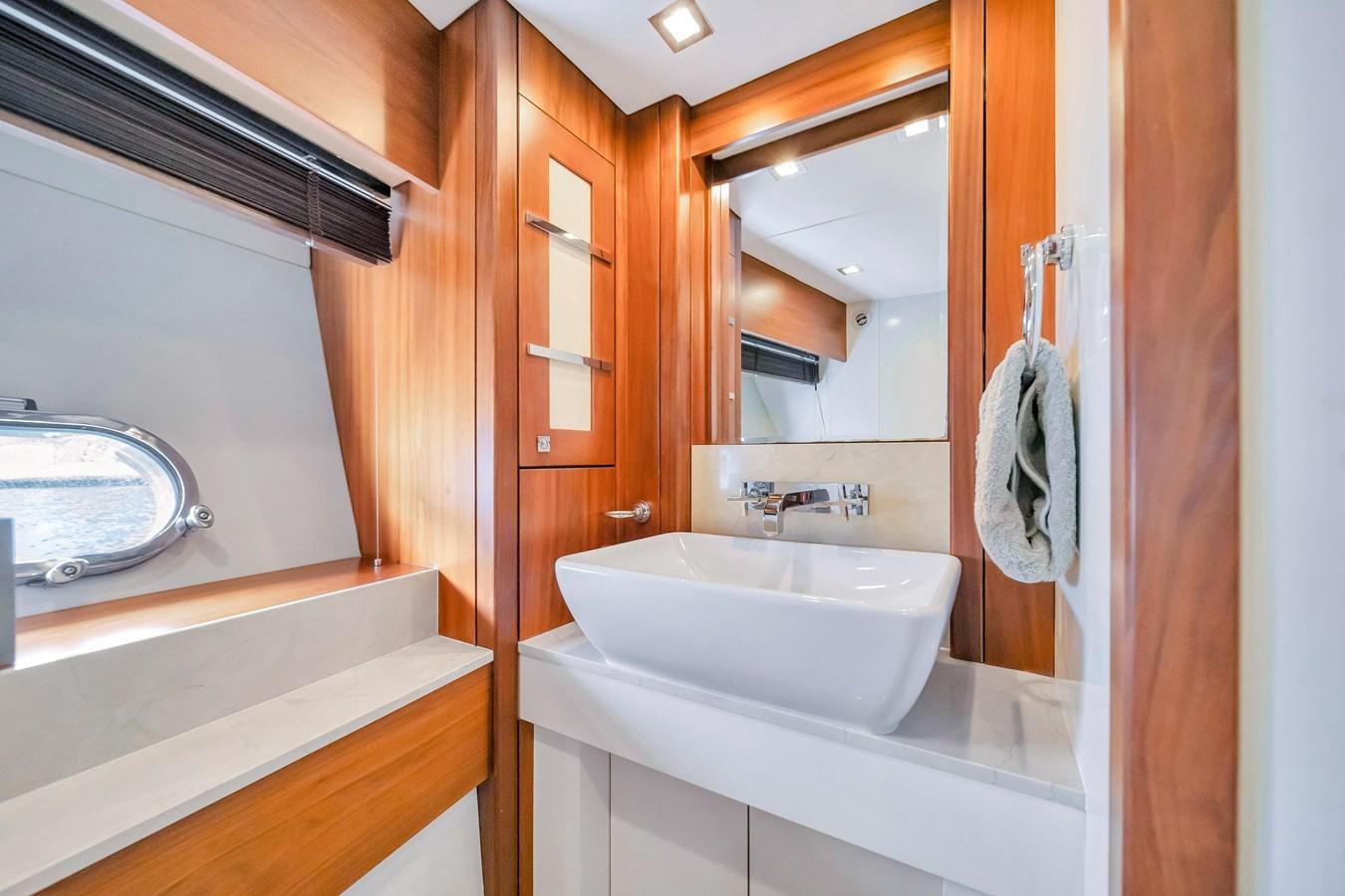 a bathroom with a sink and mirror aboard QUATTRO Yacht for Sale