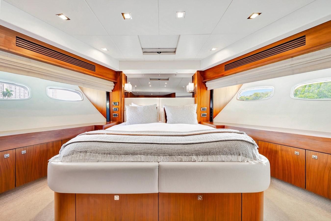 a room with a bed and a window aboard QUATTRO Yacht for Sale