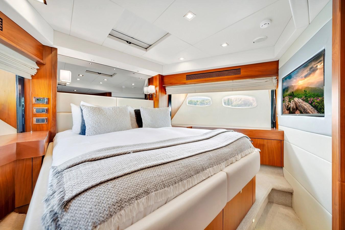 a bedroom with a bed and a desk aboard QUATTRO Yacht for Sale